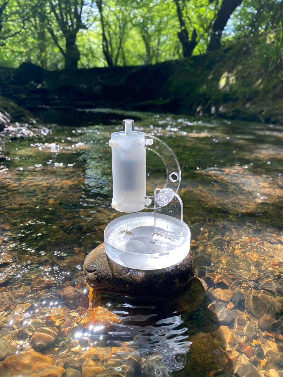 portable pod wholeness unit sitting on a rock in a stream